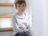 Dreng sidder på trappe